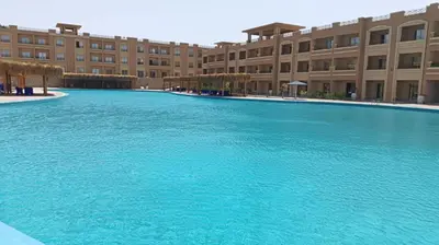 a large swimming pool in front of a building at Bay View, Sahl Hashish in Hurghada
