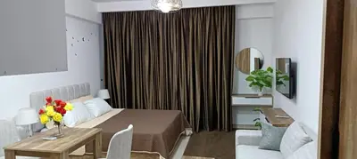 a room with a bed and a table with flowers on it at Bay View, Sahl Hashish in Hurghada