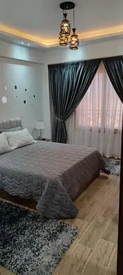 a bedroom with a large bed and a window at 2 bedroom apartment Bay View sahl hasheesh in Hurghada