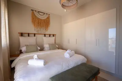 a bedroom with a bed with two towels on it at Chic Cyan 4BR Villa with Private Pool in Hurghada