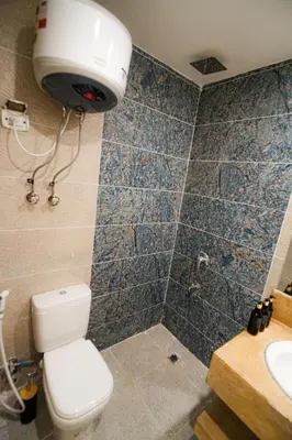 a bathroom with a toilet and a shower and a sink at modern studio- 7 min from aswan station in Aswan