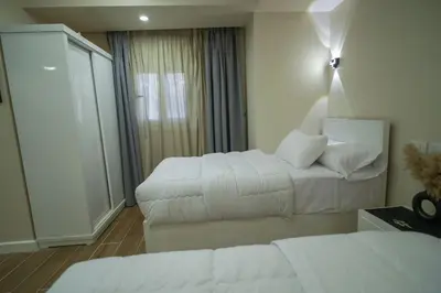 a hotel room with two beds and a window at modern studio- 7 min from aswan station in Aswan