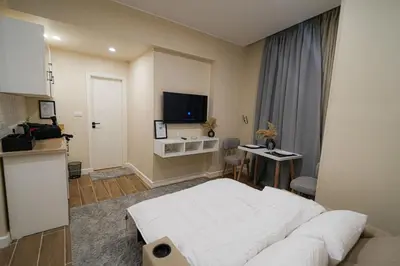 a bedroom with a bed and a table and a television at modern studio- 7 min from aswan station in Aswan