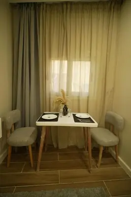 a table and two chairs in front of a window at modern studio- 7 min from aswan station in Aswan