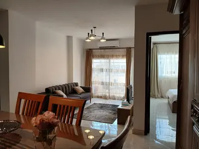 a living room with a table and a couch at Flat 10 minutes from the airport in Hurghada