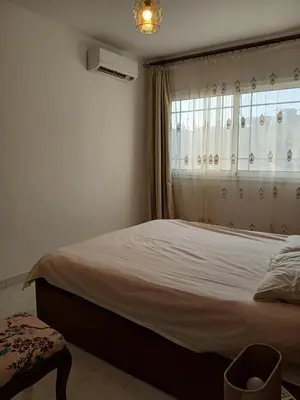 a bedroom with a large bed and a window at Flat 10 minutes from the airport in Hurghada