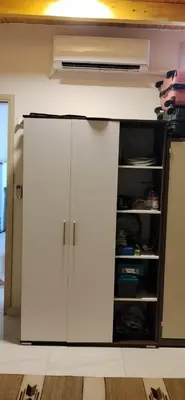 a white cabinet in a room with a shelf at in luxor apartment in Luxor