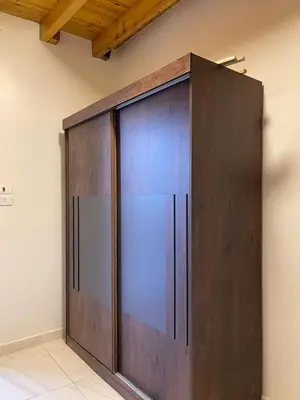 a large wooden door in the corner of a room at in luxor apartment in Luxor