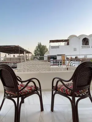two chairs sitting in front of a baseball stadium at in luxor apartment in Luxor