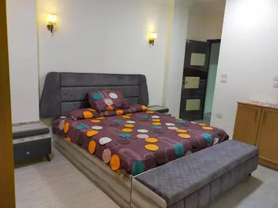 a bedroom with a large bed with a colorful comforter at Apartment in villa in Magawish in Hurghada