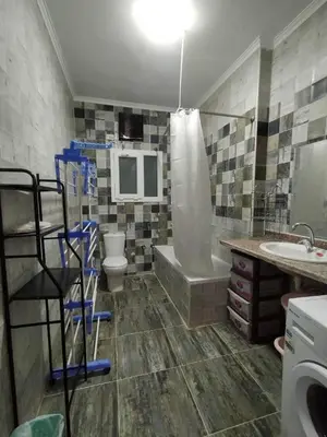 a bathroom with a tub and a toilet and a sink at Apartment in villa in Magawish in Hurghada