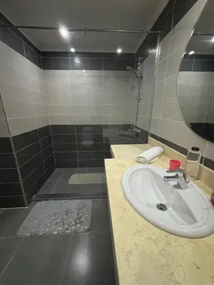 a bathroom with a sink and a shower at Fanadir Bay Resort Canary Apartman in Hurghada