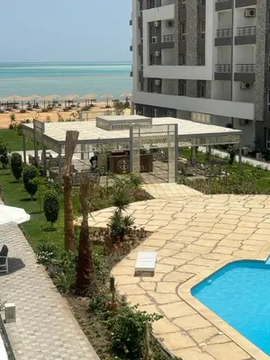 a resort with a swimming pool and the beach at Fanadir Bay Resort Canary Apartman in Hurghada