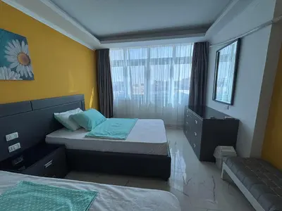 a small bedroom with two beds and a window at Fanadir Bay Resort Canary Apartman in Hurghada