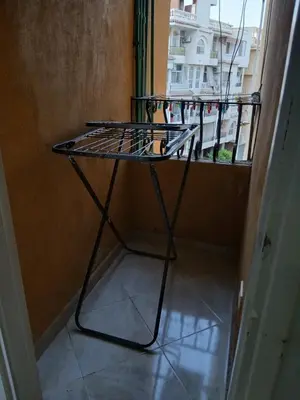 a iron table in a room with a balcony at شقه مميزه في عرابيا الغردقه امام فندق بيروت in Hurghada