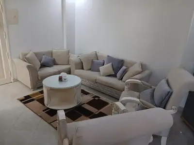 a living room with a couch and a table at شقه مميزه في عرابيا الغردقه امام فندق بيروت in Hurghada