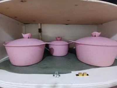 three pink pots sitting on top of a sink at شقه مميزه في عرابيا الغردقه امام فندق بيروت in Hurghada