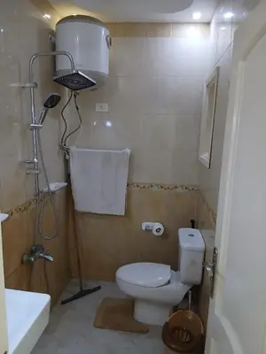 a small bathroom with a toilet and a sink at شقه مميزه في عرابيا الغردقه امام فندق بيروت in Hurghada