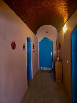 a hallway with two blue doors in a building at FairHaven Apartments in Luxor