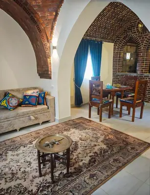 a living room with a couch and a table at FairHaven Apartments in Luxor