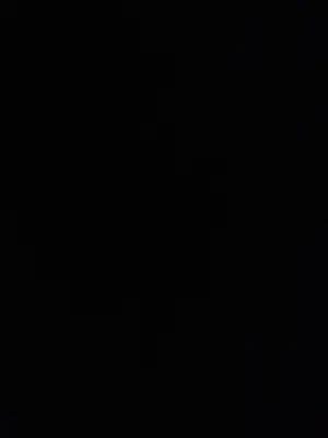 a dark room with a black background with a candle at Cozy Apartment with Red Sea view and pool access in Hurghada in Hurghada