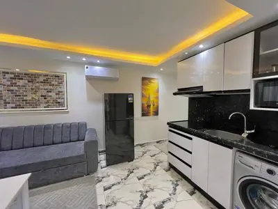 a kitchen with a couch and a sink in a room at Hurghada Hub Resort in Hurghada