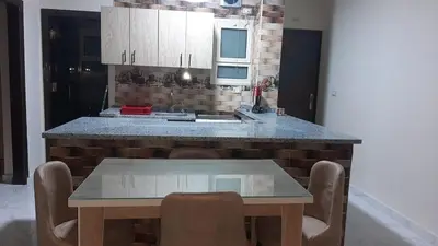 a kitchen with a table and a counter top at الغردقة شارع مترو in Hurghada