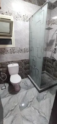 a bathroom with a toilet and a glass shower at الغردقة شارع مترو in Hurghada
