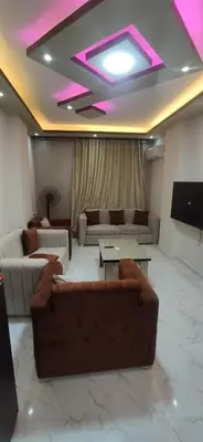 a living room with couches and a flat screen tv at الغردقة شارع مترو in Hurghada