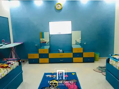 a room with two beds and a blue wall at Paradise Gates Hurghada in Hurghada