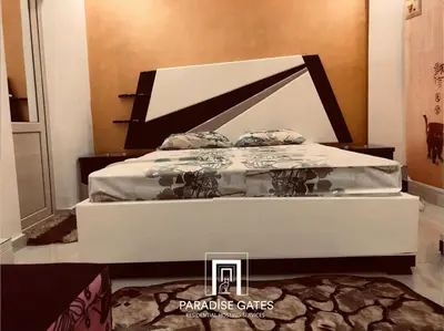 a white bed in a room with at Paradise Gates Hurghada in Hurghada