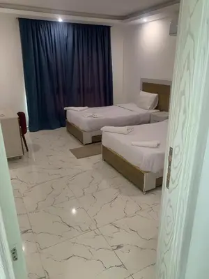 two beds in a room with a marble floor at Fanadir Bay Premier all inclusive resort in Hurghada