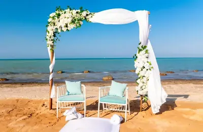a wedding arch on the beach with two chairs and avation at Fanadir Bay Premier all inclusive resort in Hurghada