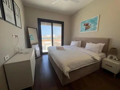 a bedroom with a large bed and a large window at Cyan Luxe Retreat 3Bdr in Hurghada