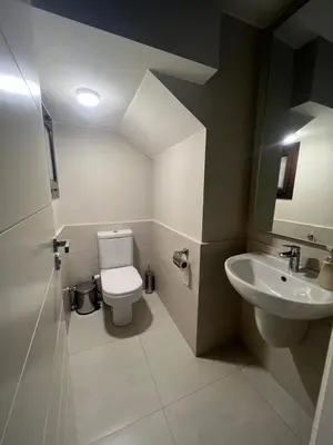 a bathroom with a toilet and a sink at Cyan Luxe Retreat 3Bdr in Hurghada
