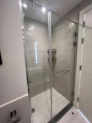 a shower with a glass door in a bathroom at Cyan Luxe Retreat 3Bdr in Hurghada
