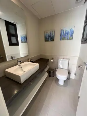 a bathroom with a sink and a toilet at Cyan Luxe Retreat 3Bdr in Hurghada