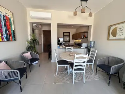 a dining room with a table and chairs at Cyan Luxe Retreat 3Bdr in Hurghada