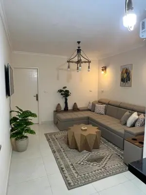 a living room with a couch and a table at Chic studio at a modern resort in Hurghada