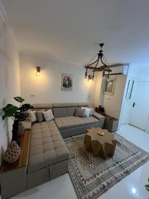 a living room with a couch and a table at Chic studio at a modern resort in Hurghada