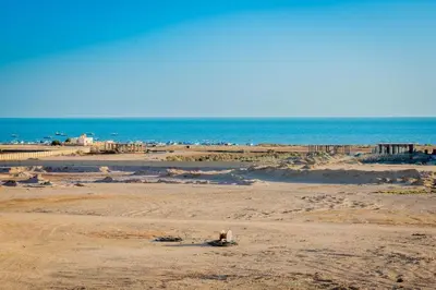 an empty beach with the ocean in the background at Chic studio at a modern resort in Hurghada