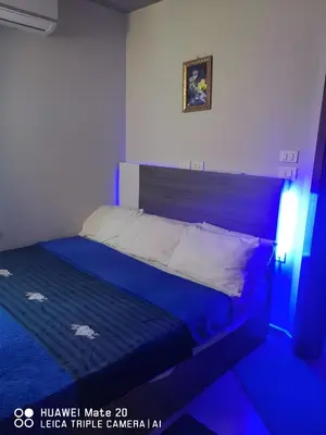 a bed in a room with blue lighting at Princess Beachfront Resort Hurghada in Hurghada