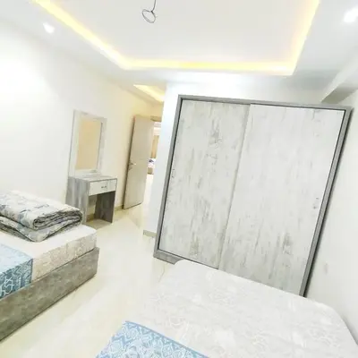 a bedroom with two beds and a mirror at Princess Beachfront Resort Hurghada in Hurghada