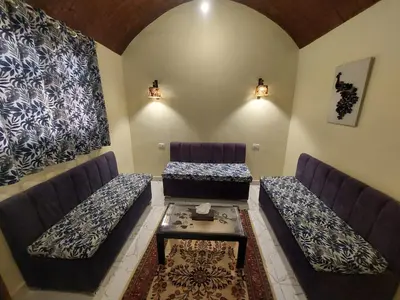 a living room with two couches and a table at Carter Guesthouse Luxor 4 in ‘Ezbet Abu Ḥabashi