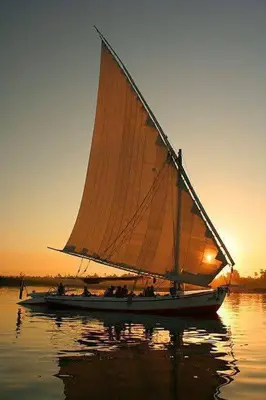 a group of people on a sail boat in the water at the golden house in Luxor