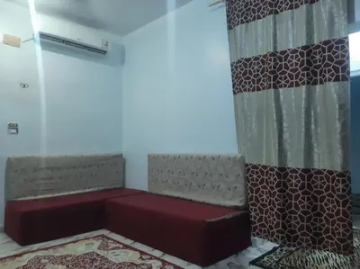 a room with a red bench in a room at the golden house in Luxor