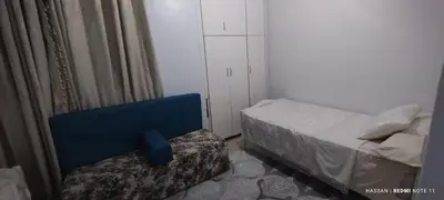 a small bedroom with a bed and a chair at the golden house in Luxor