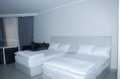 a white bed with white pillows in a room at Sea view studio in Hurghada