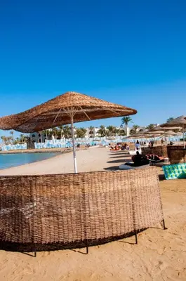 a beach with two chairs and an umbrella on the sand at Sea view studio in Hurghada