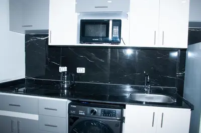 a kitchen with a sink and a microwave at Sea view studio in Hurghada